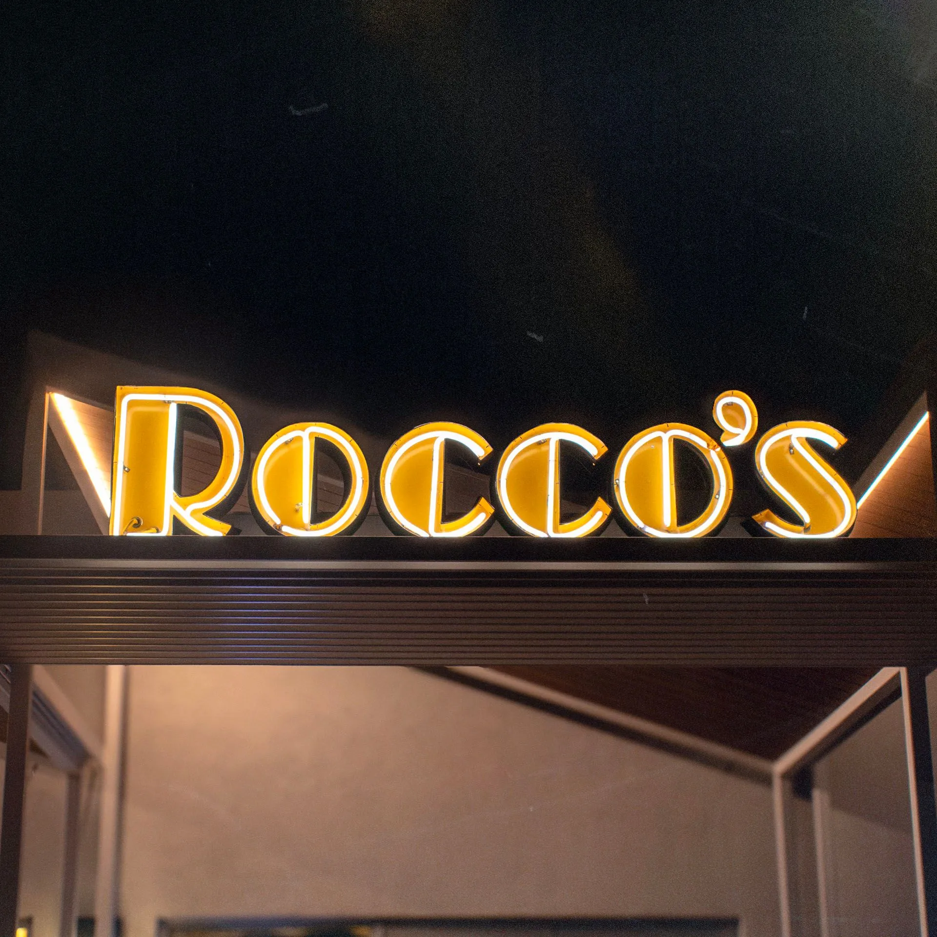 Roccos entrance with neon sign